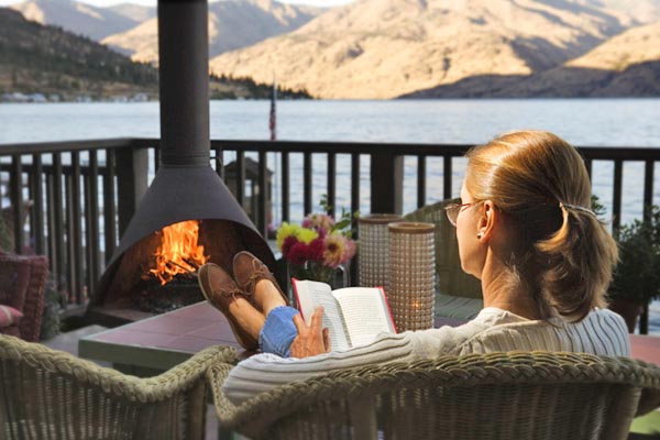 lady reading on deck overlooking lake chelan